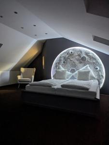 a bedroom with a bed with a moon mural on the wall at Himmel Suite in Schönau an der Brend
