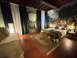 a bedroom with two beds and a painting on the wall at La Celeste Galeria in Mantova +209 photos