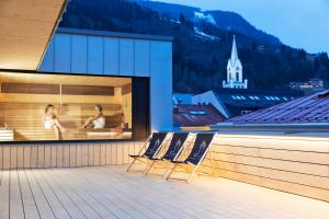 a group of chairs sitting on a balcony at Stadthotel Brunner in Schladming