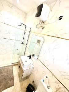 a bathroom with a sink and a shower at Two Bedroom Home in Lekki in Lekki
