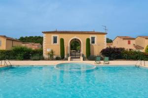 ein großes Schwimmbad vor einem Haus in der Unterkunft Villa climatisée avec piscine in Vaison-la-Romaine