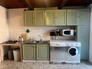 a kitchen with a washing machine and a sink at U Magazinu in Pino +20 photos
