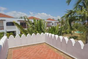 a white picket fence in front of a house at Victorious Kings Homes in Mtwapa