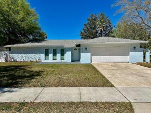 a large white house with a driveway at Orlando Luxe Retreat with Private Pool in Orlando