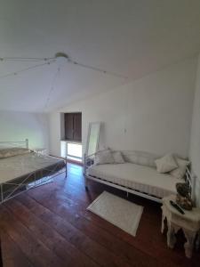a white living room with a couch and a table at la valle country house in Vasto