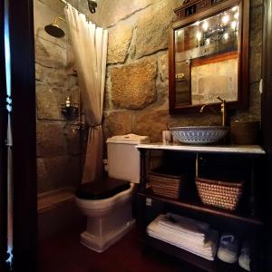 a stone bathroom with a toilet and a sink at Castelo de Portugraal in Vilela +38 photos