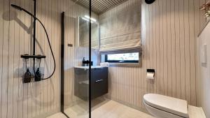 a bathroom with a shower and a toilet at Premium Chalet with Grand View in Sørvågen +49 photos