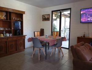 a dining room with a table and chairs at Hostal Rucatremo in Curicó