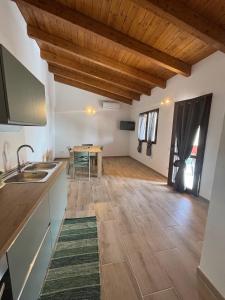 a kitchen and dining room with wooden ceilings and a table at Casa Ottema 3 in Nebida