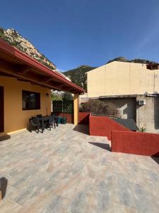 a patio with tables and chairs and a building at Casa Ottema 3 in Nebida +185 photos