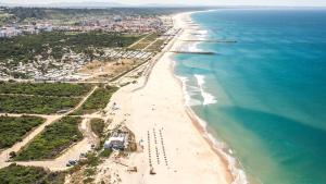 an aerial view of a beach and the ocean at Mountain View Beach House in Costa da Caparica