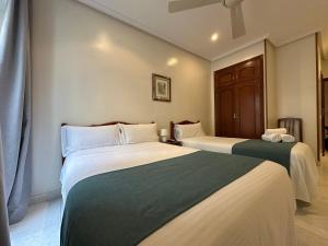 Łóżko lub łóżka w pokoju w obiekcie Hostal Villamañez