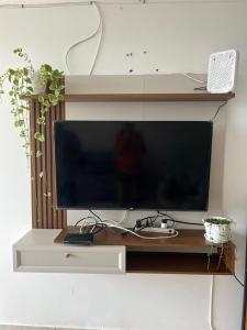 a large flat screen tv sitting on a wooden stand at Comfortable duplex - Punta Hermosa in Punta Hermosa