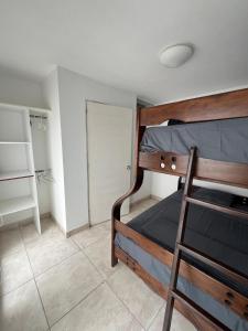 a bedroom with a wooden bunk bed with a closet at Comfortable duplex - Punta Hermosa in Punta Hermosa +15 photos