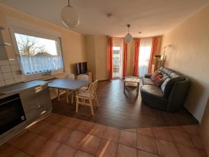 a living room with a couch and a table at Ferienwohnung Koserow in Koserow