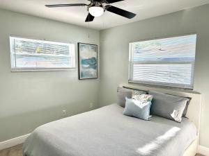 a bedroom with a bed with a ceiling fan at Orlando Luxe Retreat with Private Pool in Orlando +64 photos