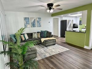 a living room with a couch and a ceiling fan at Orlando Luxe Retreat with Private Pool in Orlando