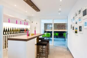 una sala de degustación con un bar con sillas verdes en SCHLAFGUT Domhof erleben en Guntersblum