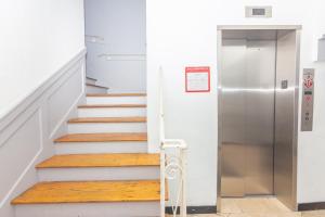 a staircase with a metal elevator in a building at Ocean Villa in Miami Beach