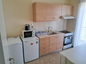 a kitchen with a white refrigerator and a microwave at ☆Minimal 6 floor Apartment in the Center of Patras in Patra