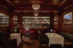 a restaurant with tables and chairs and a bar at The Maybourne Beverly Hills, Maybourne in Los Angeles