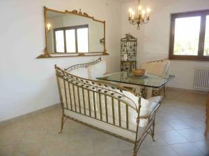 a dining room with a mirror and a glass table at Casa Paradiso in Porto Valtravaglia