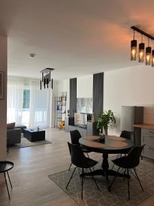 a living room with a table and chairs at Deluxe Apartment Ruhr Oase, Neubau, 4 Personen, Parkplatz, in Bochum +12 photos