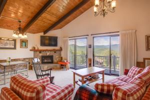 a living room with couches and a fireplace at Mountaintop Condo with Great Mt Washington View in Glen