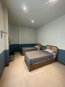 a bedroom with two beds in a room at Cana House Coffee & Stay in Sentool