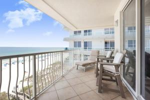 a balcony with chairs and a view of the beach at Emerald Key 603- Wrap Around Balcony Top Floor in Orange Beach