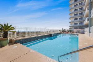 a swimming pool with a view of the ocean at Emerald Key 603- Wrap Around Balcony Top Floor in Orange Beach