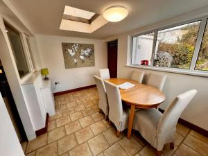a dining room with a wooden table and chairs at Comfy Cottage in Ballymena +11 photos