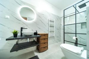 a bathroom with a sink and a mirror at Apartman Petra s pogledom na more in Banjol +15 photos