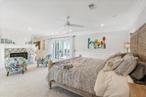 a bedroom with a large bed and a fireplace at 8 Sea Front, Oceanfront Estate, Pool, Game Room, Elevator in Hilton Head Island +122 photos