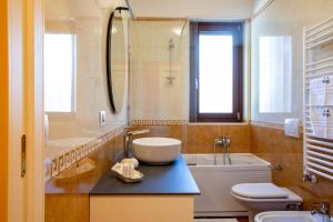 a bathroom with a sink and a toilet and a tub at B&B Casa Ferrulli Altamura in Altamura +16 photos