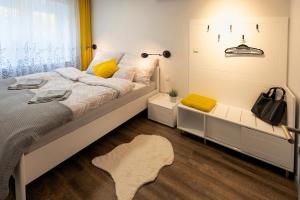a bedroom with a large bed and a window at Hóvirág Apartman in Hódmezővásárhely