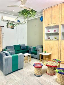 a living room with couches and tables and chairs at Vi Homes-A 4BHK HomeStay in Jaipur
