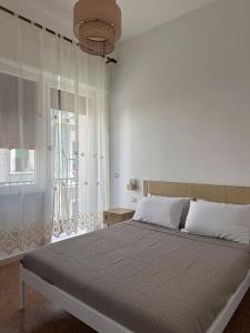a bedroom with a large bed and a window at Giardino del Geco in Brindisi
