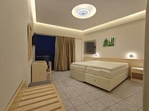Ένα ή περισσότερα κρεβάτια σε δωμάτιο στο New Aegli Resort Hotel