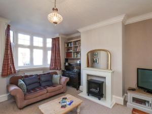 a living room with a couch and a fireplace at 43 Springvale in Whitby