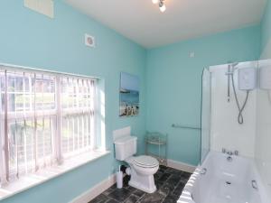 a bathroom with a tub and a toilet and a window at 43 Springvale in Whitby +27 photos