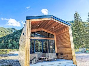 a small wooden cabin with a table and chairs at Holiday Home Tiny Haus Glockenalm-Chalet Alpenzauber by Interhome in Aurach +15 photos