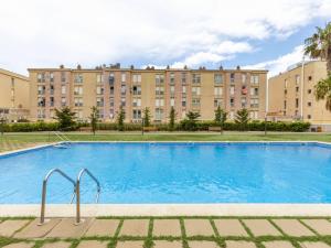 a large swimming pool in front of a large building at Apartment Puig Sapera by Interhome in Sant Antoni de Calonge