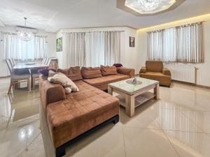a living room with a couch and a table at Holiday Home Maja by Interhome in Donji Proložac