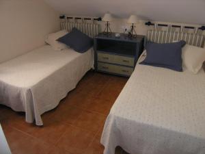 two beds sitting next to each other in a room at Comfortable penthouse in Islantilla golf in Lepe +28 photos