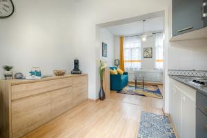 a kitchen with white walls and a wooden counter top at Terrasse privée & Lumineux Gare 2 min in Valenciennes