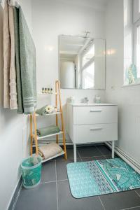 a bathroom with a sink and a ladder and a mirror at Terrasse privée & Lumineux Gare 2 min in Valenciennes