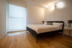 a bedroom with a bed and a large window at Luxury London Apartment in London