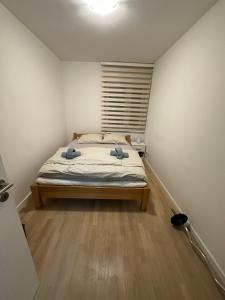 a bedroom with a bed with two pillows on it at Apartman Pionir in Sarajevo