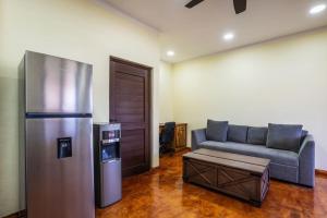 a living room with a couch and a refrigerator at Costa Coral in Cabo Pulmo